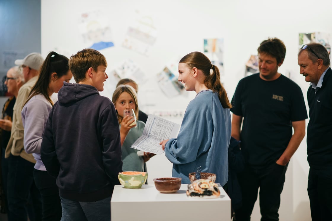 Student artists with their artworks at the exhibition opening of What the Eyes Cannot See exhibition, photo by Dan Paris, Cannery Arts Centre